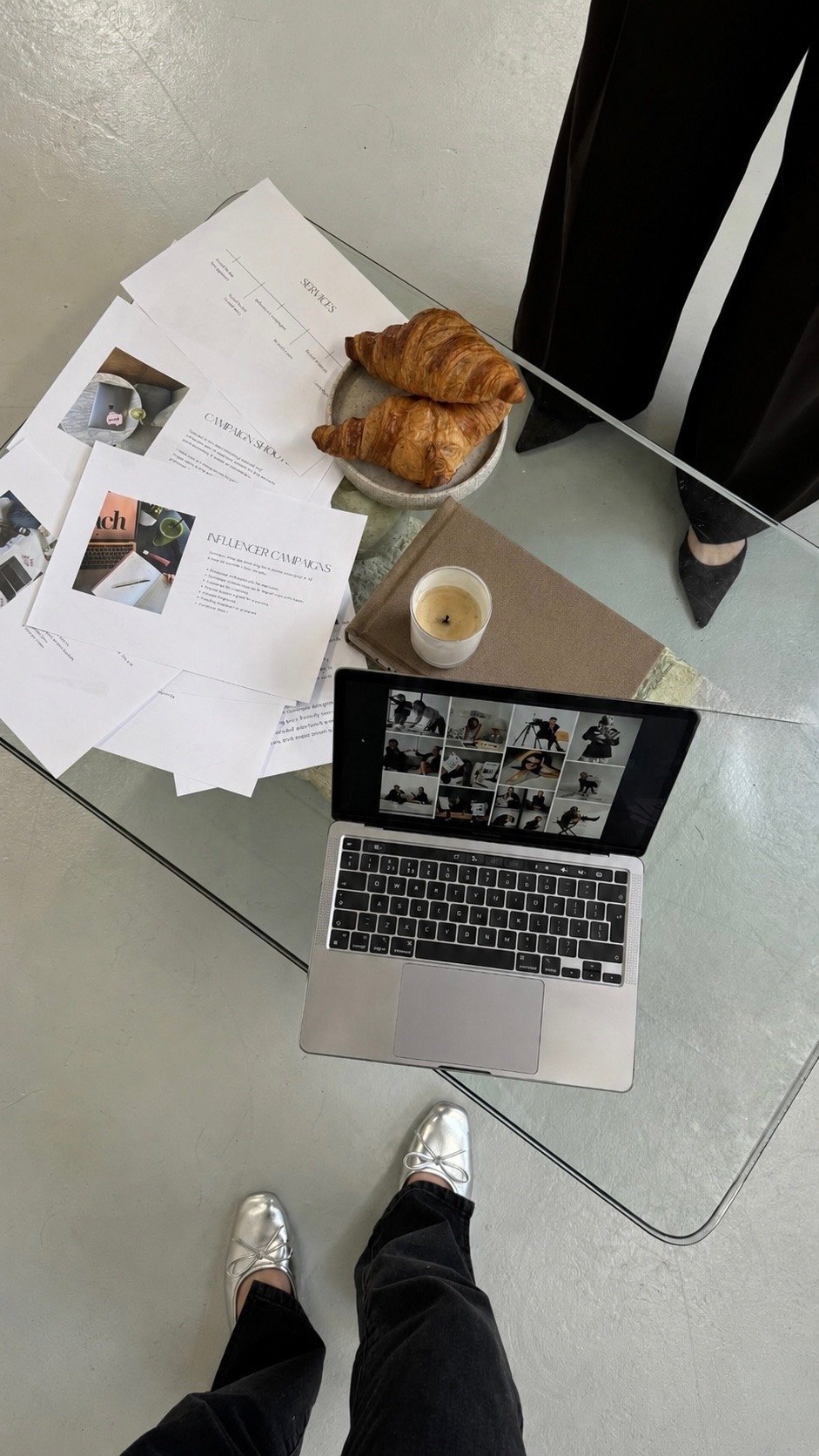 Campaign planning flat-lay with laptop and croissants